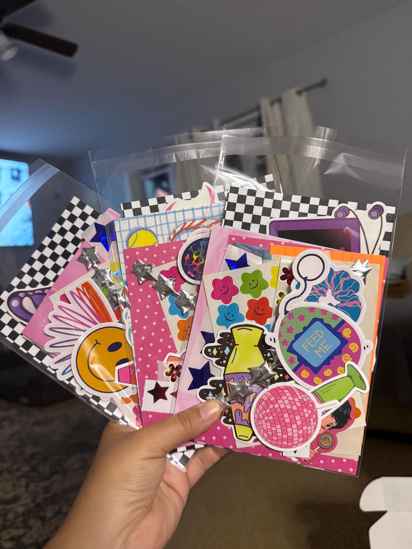 Y2K inspired scrap pack with colorful ephemera including retro stickers, magazine clippings, holographic accents, and playful 2000s-style graphics